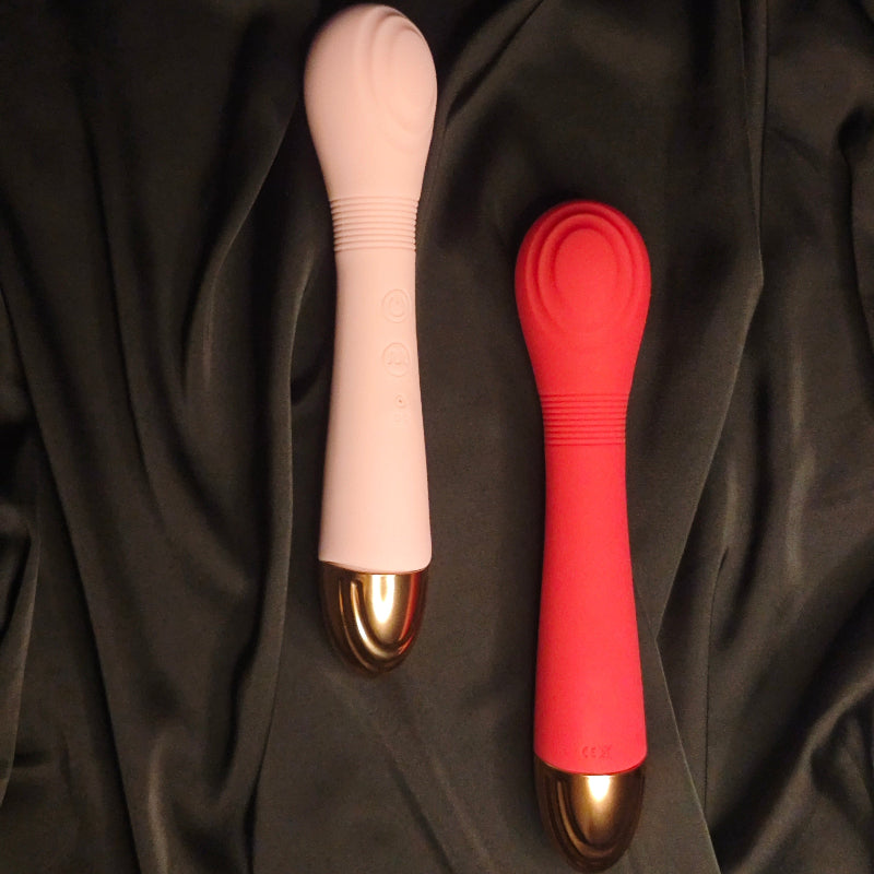 GIMMESEX double-headed tongue vibrator in pink and red with curved silicone heads on black fabric