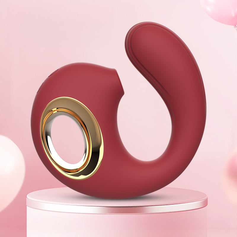 GIMMESEX elegant red G spot vibrator with gold accents on a pink pedestal