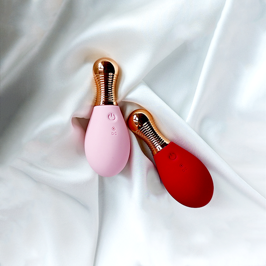 GIMMESEX pink and red remote control vibrator with rose gold accents on white fabric