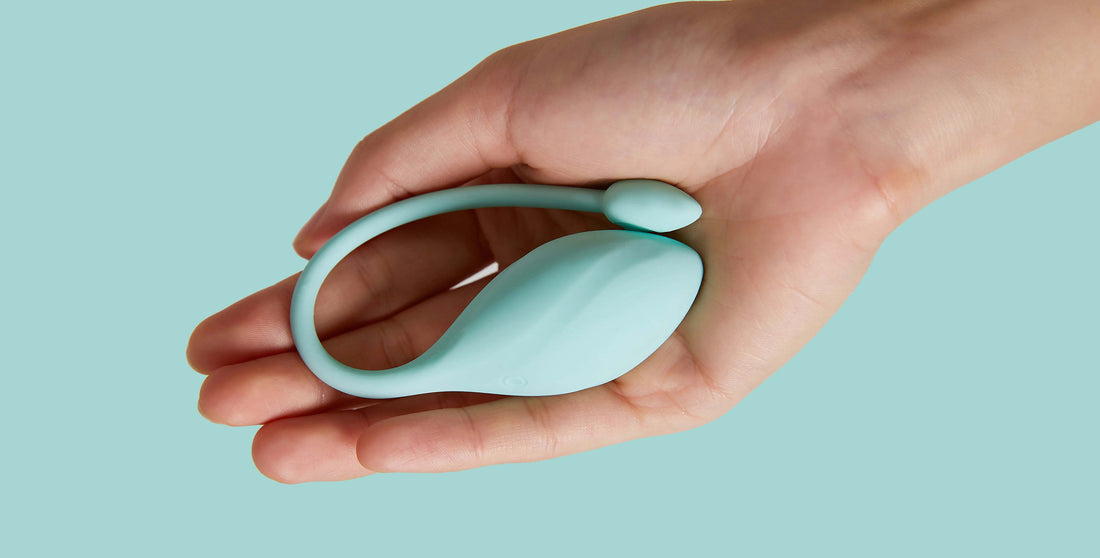 Hand holding a light blue Kegel ball device demonstrating how to use Kegel balls effectively