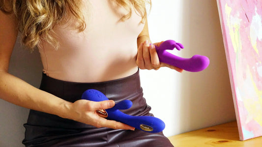 Woman holding purple and blue rabbit vibrators demonstrating how to use a rabbit vibrator for beginners
