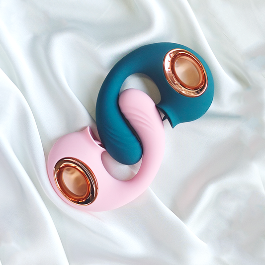 GIMMESEX dual color G spot vibrator in pink and teal with rose gold accents on white fabric
